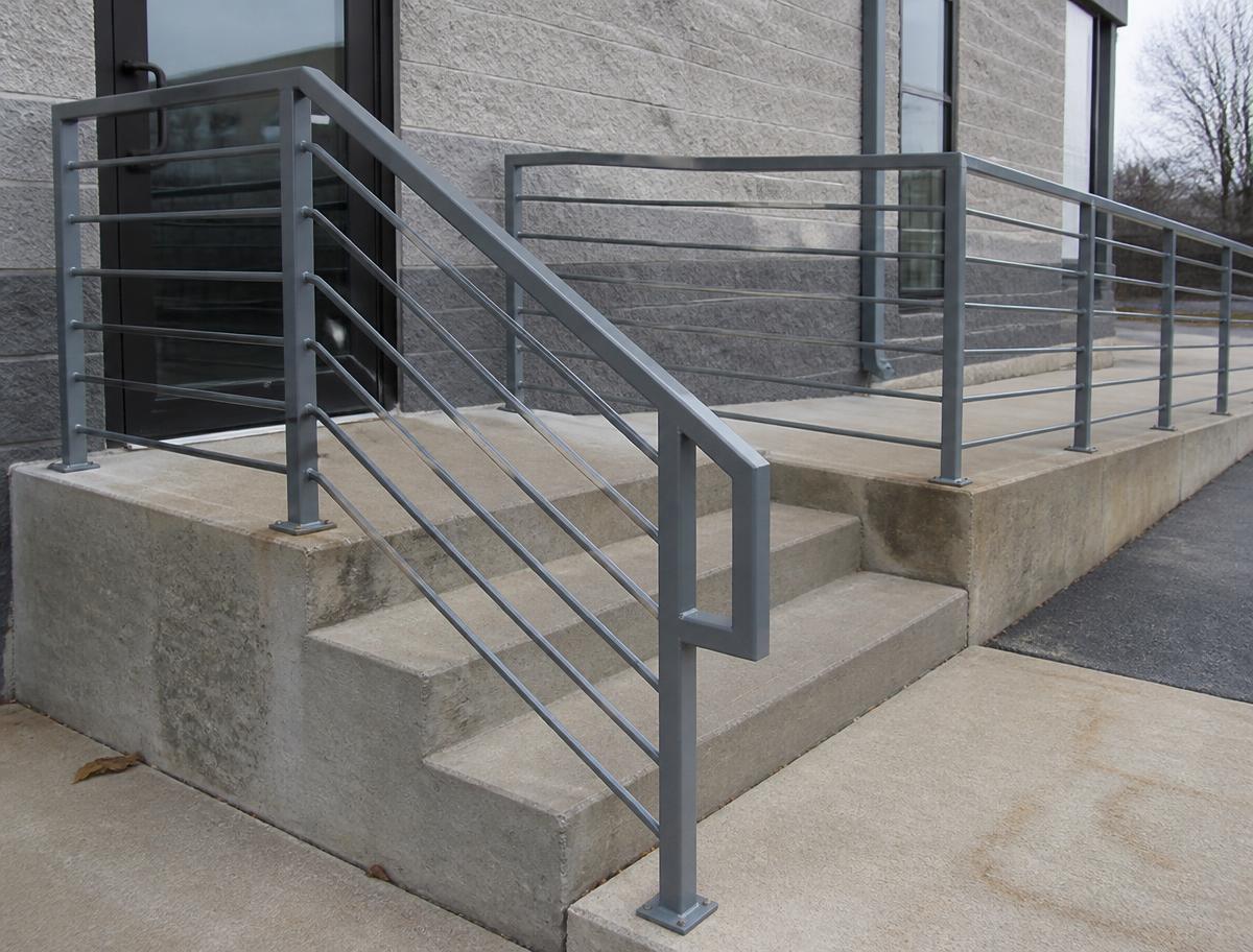 Fabricated steel handrail installed at a commercial entrance